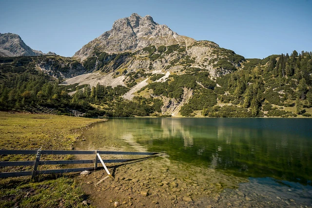 Old fence sticks into the lake Seebensee