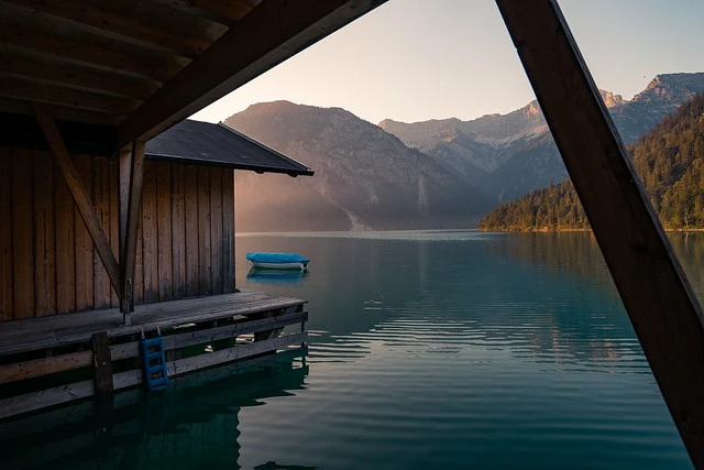 Boathouse at sunrise at lake Plansee