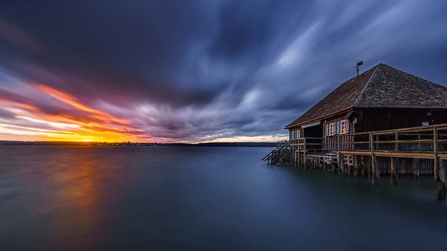 Sunset at lake Ammersee with an old Boathouse