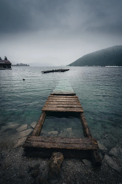 Old damaged Jetty on a rainy day in the Bavarian Alps