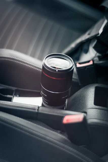Samyang 35mm f1.4 lens on the seat of VW Scirocco
